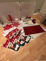 Full lot photo showing all Christmas decor items including stockings, placemats, tree displays, advent bags and ornaments
