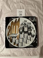 Front of the decorative plate showing artistic calendar design for 2011 with owls and multilingual greetings