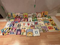 Full layout of kids' books showing multiple titles including farm animals, rain rain go away, words, colors, opposites, and popular characters.