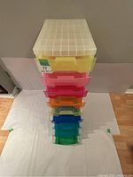 View from the top showing stacked colorful translucent drawers in a clear plastic frame.