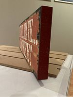 Side view showing the thickness and distressed look of the 'MUST... HAVE... COFFEE!' plaque.