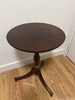 Top view of the round wooden side table showing smooth finished surface and rich wood grain.
