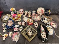 Full layout of all 31 ceramic masks showing variety of sizes and designs.