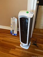Front view of Aera Max DX5 air purifier and two boxes of HEPA filters in packaging.