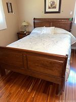 Assembled queen bed with headboard, footboard and bedding