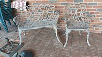 Metal outdoor chair and settee showing full view and spatial relationship