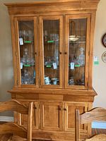 Full front view of the two-piece cabinet showing upper glass doors, lower wood doors, and overall height and width.