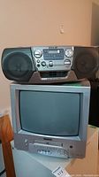 Sony portable radio cassette CD player on top of Citizen TV and DVD combo unit, showing front side and speakers