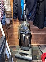 Full view of the upright Hoover vacuum cleaner showing the twin chamber bagless dust containers and hose attachment.