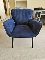 Front view of a blue corduroy fabric chair showing seat, backrest, and armrests