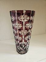 Front view of the purple and clear cut glass vase showing shape and pattern