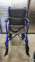 Front view of the blue Drive Expedition X Series manual wheelchair showing the seat, backrest, armrests, and footrests.
