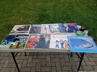 Full table view showing 11 vintage vinyl albums with various artists, genres rock and pop, all with visible cover art.