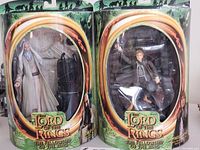 Two Lord of the Rings action figures in original packaging: Saruman the White and Samwise Gamgee.