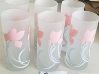 Photo showing six frosted glasses with pink iris motifs and white swirled decoration, signed 'Cerve' Italy.