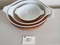 Set of three nested vintage Pyrex Old Orchard mixing bowls showing interior and exterior colors and pattern
