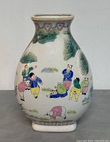 Front view of Chinese porcelain vase showing painted figures of children playing outdoors with surrounding trees and rocks.