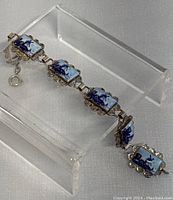 Close-up photo of the 7" vintage Delft bracelet showing detailed blue hand-painted ceramic tiles set in ornate silver frames.