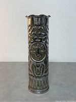 Front view of tall vintage metal vase showing full height and scalloped rim.
