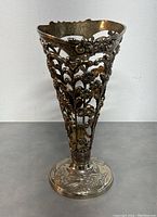 Front view of the silver-plated vase showing intricate openwork floral pattern and decorative base