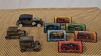 Overview of all collectible model cars and coin banks, some boxed and some loose