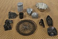 Full lot image showing fluted mold, heart tins stacked, vintage cookie cutters of various shapes including an animal