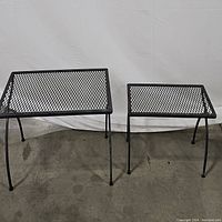 Both nesting wrought iron patio tables side by side showing size difference and design.