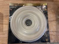 Packaged round 18 inch ceiling medallion with white finish and decorative ring details.
