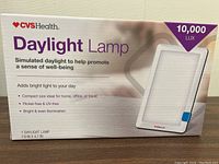 Photo of the boxed CVS Health Daylight Lamp showing front of packaging with product details and specifications.