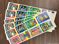 Photo showing six full strips of Garbage Pail Kids stickers with various colorful characters.