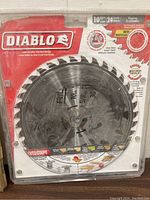 Diablo 10 inch saw blade in original red packaging. Shows blade with 24 teeth and marketing text describing laser cut thin kerf design. Photo taken to document item condition and packaging.