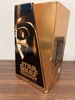 Gold slipcase box with Darth Vader image and Star Wars Trilogy Special Edition text, visible wear and scuffs.
