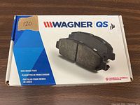 Front of Wagner QS disc brake pads box with product image and brand logo.