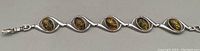 Full view of the sterling silver bracelet with amber stones showing length and style.