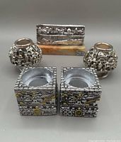 Photo showing all items in the lot: two cube candle holders with Old Jerusalem cityscape motifs and silver sculpture on marble base