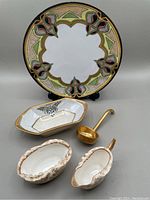 Photo of all porcelain items including Czechoslovakia salad plate, candy dish, ladle, and Doulton Burslem creamer and sugar set.