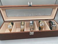 Five vintage mechanical wristwatches displayed inside a brown watch box with glass top. Shows entire lot including the box.