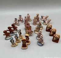 Photo showing the complete group of 25 Wade figurines arranged including gingerbread men, angels, houses, and others.