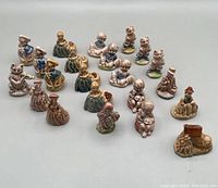 Full lot showing all 22 Wade ceramic figurines in a grouped arrangement on a light surface.