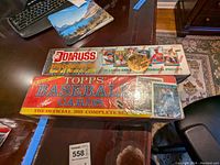 Top view of the two sealed sets: Donruss 1991 Collectors Set and Topps 1988 Official Complete Set of baseball cards on a table.