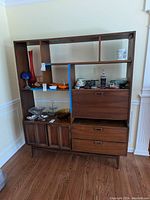 Front view of full unit showing shelving, drop-front compartment, drawers, and lower cabinet.