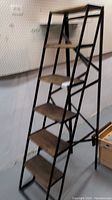 Full view of the five-tier handcrafted wood and metal plant stand