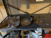 Full lot overview on shelf showing two medallions pinned to cloth and four serving pieces