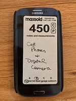 Samsung smartphone front view displaying maxsold lot label
