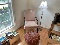Photo of entire setup showing armchair, footrest, and floor lamp by the window.