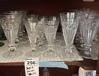 Overall view of the glassware set showing varied sizes and diamond patterned design around the top of each glass.