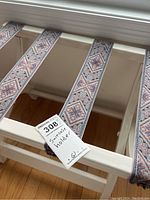 Top view showing three fabric straps with geometric patterns across the wooden frame.