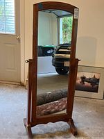 Front view showing full-length mirror, wooden frame and footed base