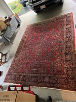 Full view of rug in garage alongside car and furniture