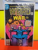 Cover of Weird War Tales #61 comic showing a skeletal figure strapped into a chair with electric stimulation, black background and yellow title text.